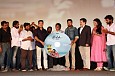 Suriya bows down to the Cuckoo team on stage at the music Launch