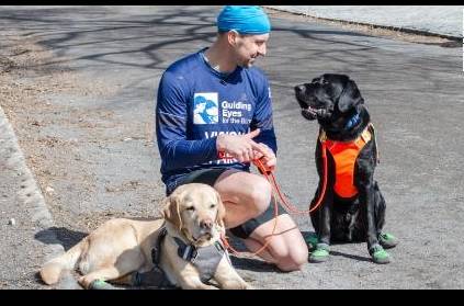 First blind person to run the race led completely by guide dogs